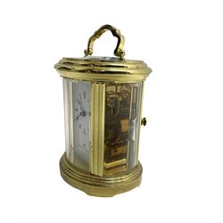 English - 20th century  8-day oval carriage clock, in a polished gilt case with an enamel dial, Roman numerals and moon hands, dial inscribed Mathew Norman, London, timepiece spring driven movement with a lever platform escapement, balance with timing screws. 