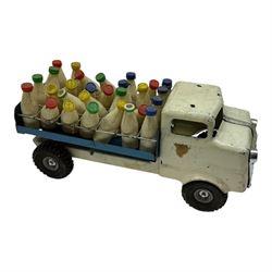 1950s Triang pressed steel milk float, containing twenty eight plastic milk bottles with coloured tops, together with a 1950s Triang pressed steel locomotive 'Triang Express', tallest H21cm