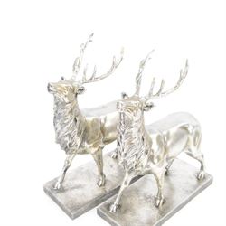 Pair of composite silvered stags, on rectangular base H37cm
