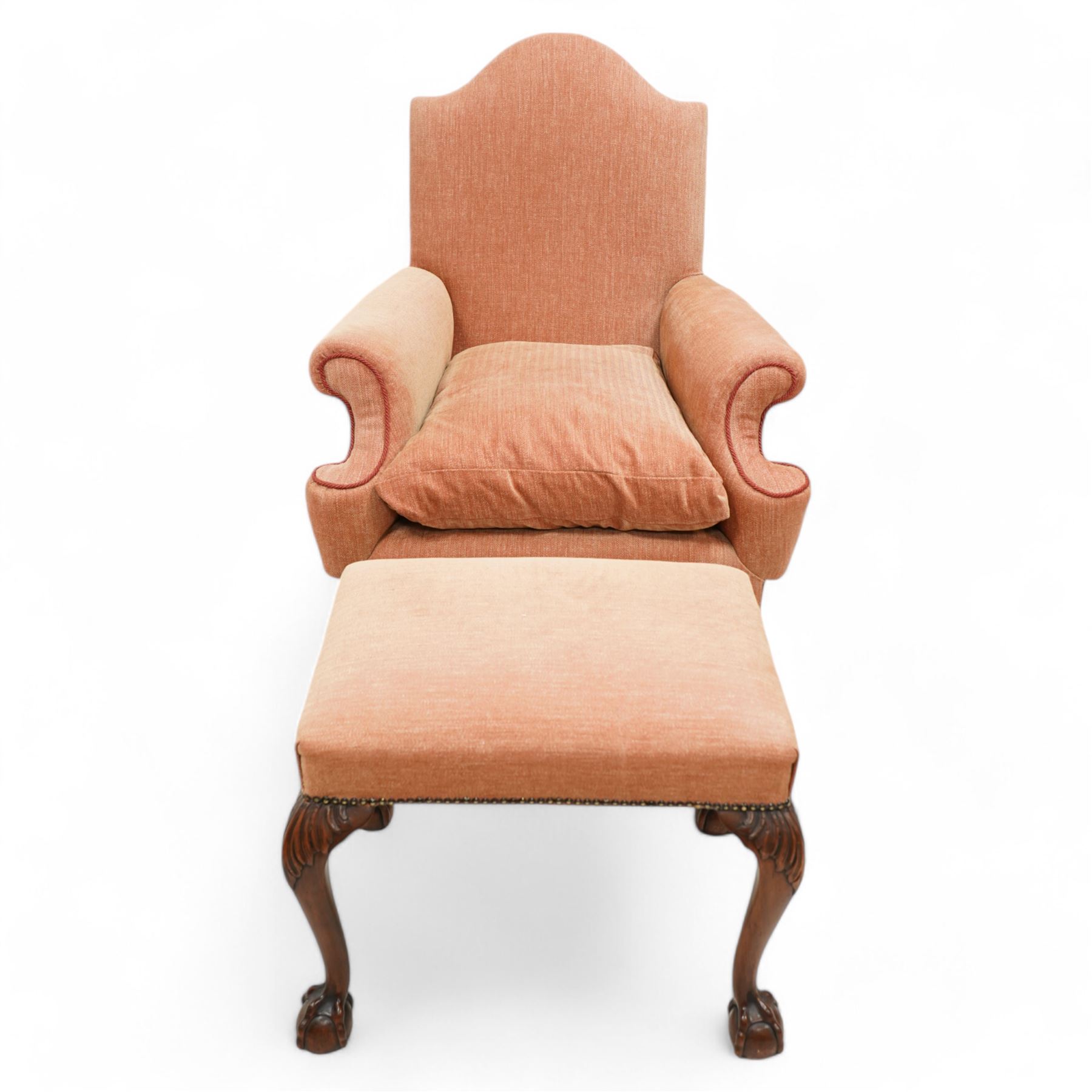 William & Mary design walnut framed armchair, arched cresting rail over rolled arms and C-scrolled arm supports, upholstered in peach herringbone fabric with contrasting rouge twist piping, on turned front feet with scrolled terminals, united by shaped and moulded X-frame stretchers with turned finial (W80cm, H106cm, D80cm); together with a Georgian design mahogany footstool, in matching upholstery with stud band, on acanthus leaf carved cabriole supports with ball and claw feet (60cm x 47cm, H47cm)