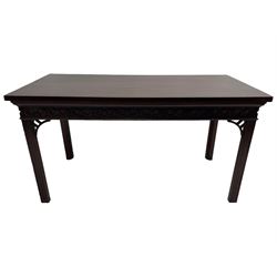 In the manner of Thomas Chippendale - early 19th century mahogany serving table, rectangular crossbanded top with boxwood stringing, the frieze with upper moulding over applied geometric fretwork, the left-hand side fitted with slide, on fluted square supports with inner chamfer 