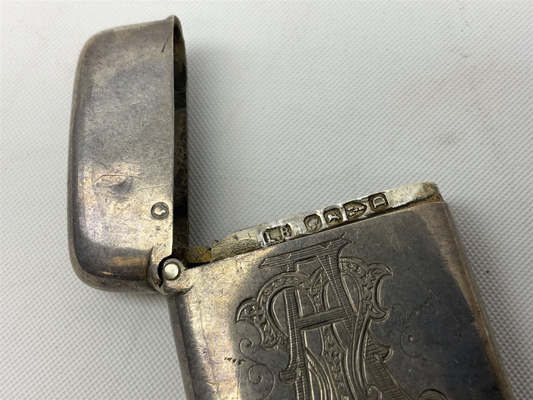 Victorian novelty brass vesta case modelled in the form of a pig holding a money bag, together with a silver vesta, hallmarked 