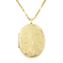 Gold oval locket with engraved decoration, on a gold fancy link chain, both 9ct, hallmarked 