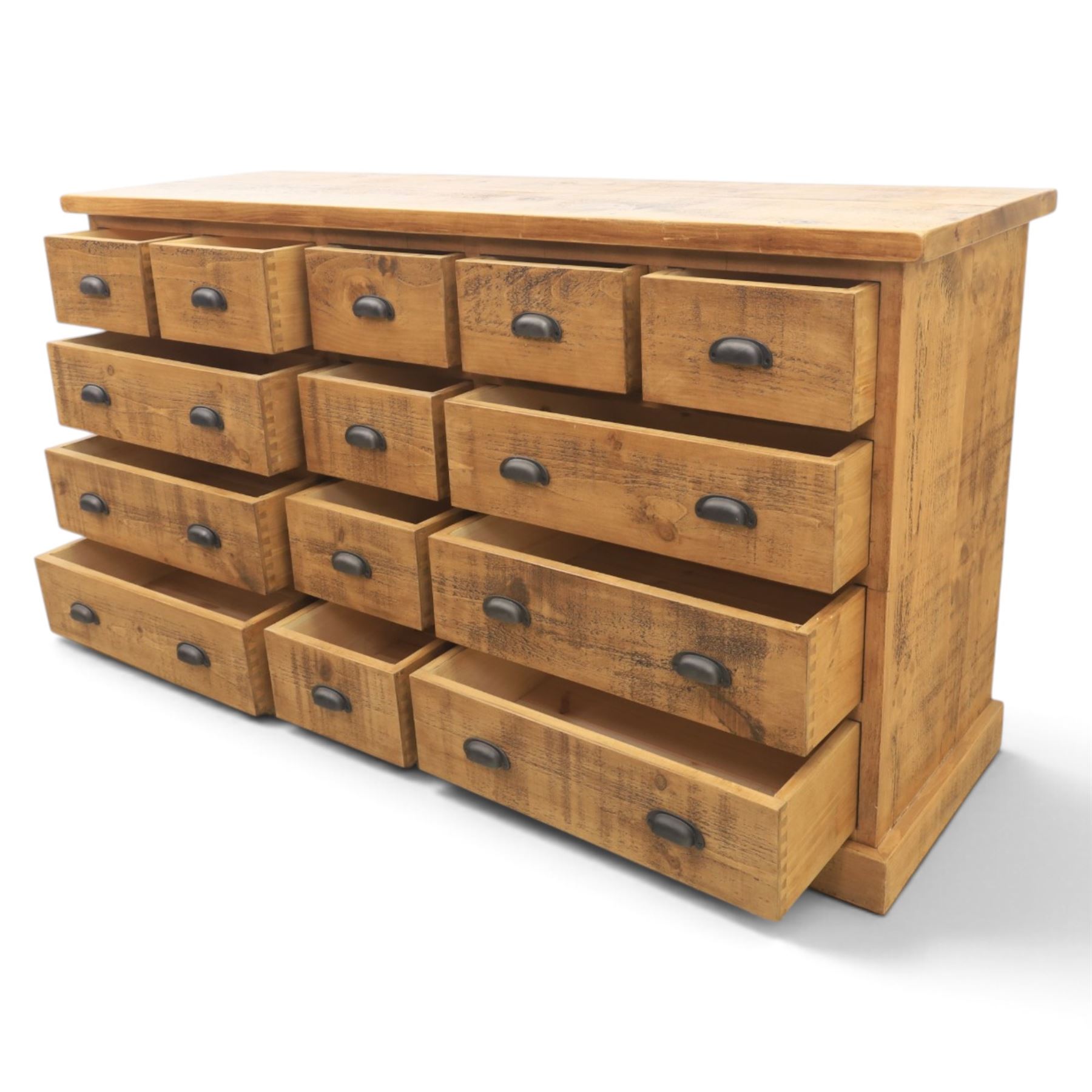 Indigo Furniture - large rustic oak combination chest sideboard, fourteen drawer with blackened metal cup handles, on a plinth base