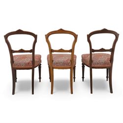 Set of six late Victorian mahogany dining chairs, the shaped top rails carved with anthemion motifs, above pierced splats, floral and geometric fabric seat, on turned and fluted front legs