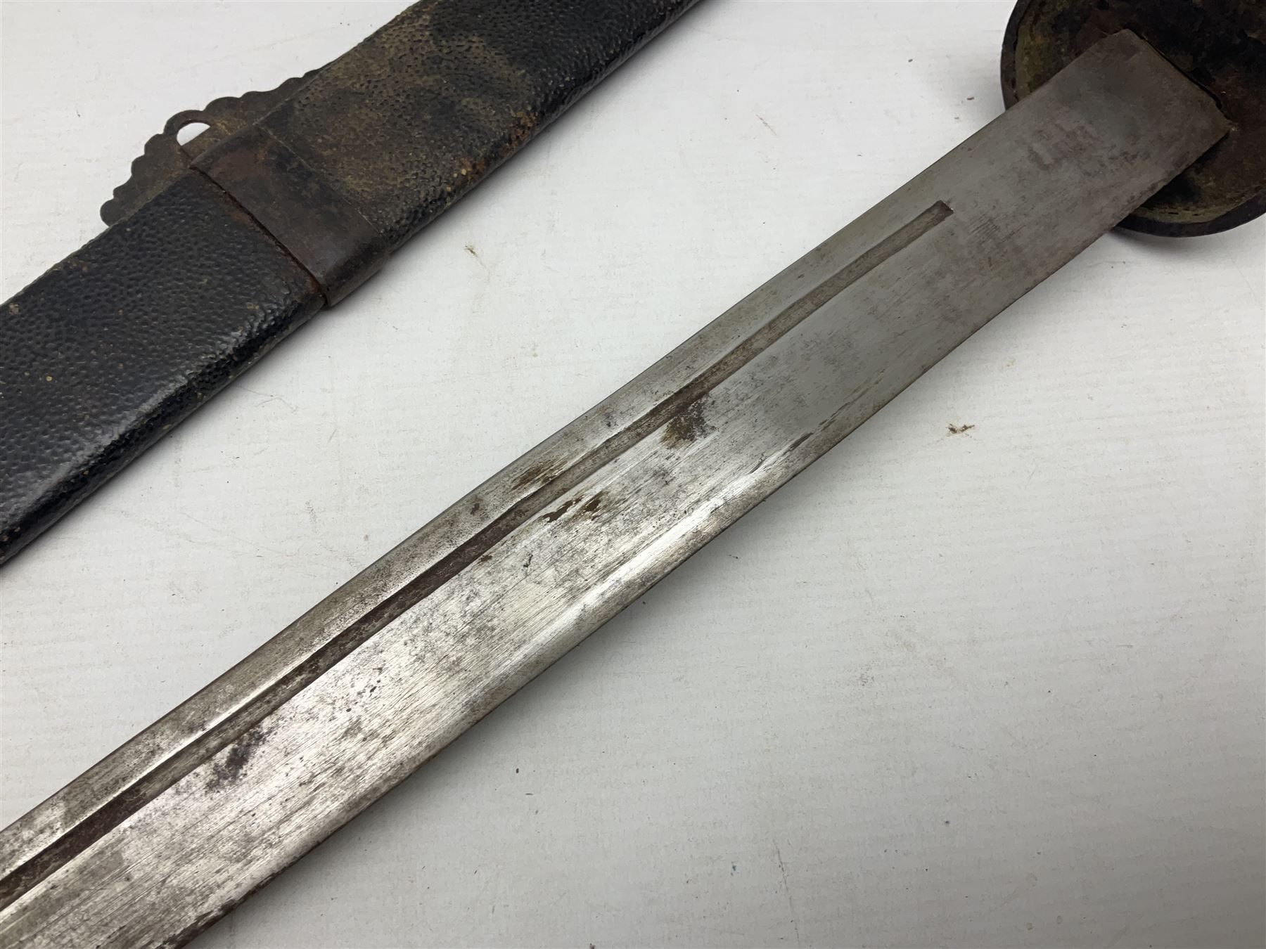 Chinese Boxer Rebellion Period Sword, 69.5cm heavy curved single edge blade with single narrow fuller, plain iron dished circular guard, iron pommel and ferrule with plaited cord bound grip; in skin covered wooden scabbard with iron chape and long suspension mount L95cm overall