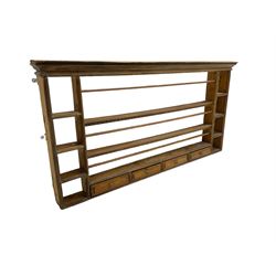 18th century pine wall hanging plate rack, projecting cornice over three tiers and four spice drawers, flanked by four tier shelves