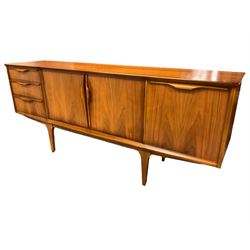 Jentique - mid-20th century teak sideboard, fitted with three drawers, double cupboard and fall front cupboard, raised on tapering supports