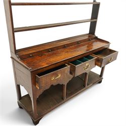 18th century Georgian oak dresser base with plate rack, the three-tier plate rack with shaped frieze, the base with rectangular top with raised back fitted with five spice drawers, over three drawers with brass swan neck handles, raised on six square chamfered supports united by undertier 