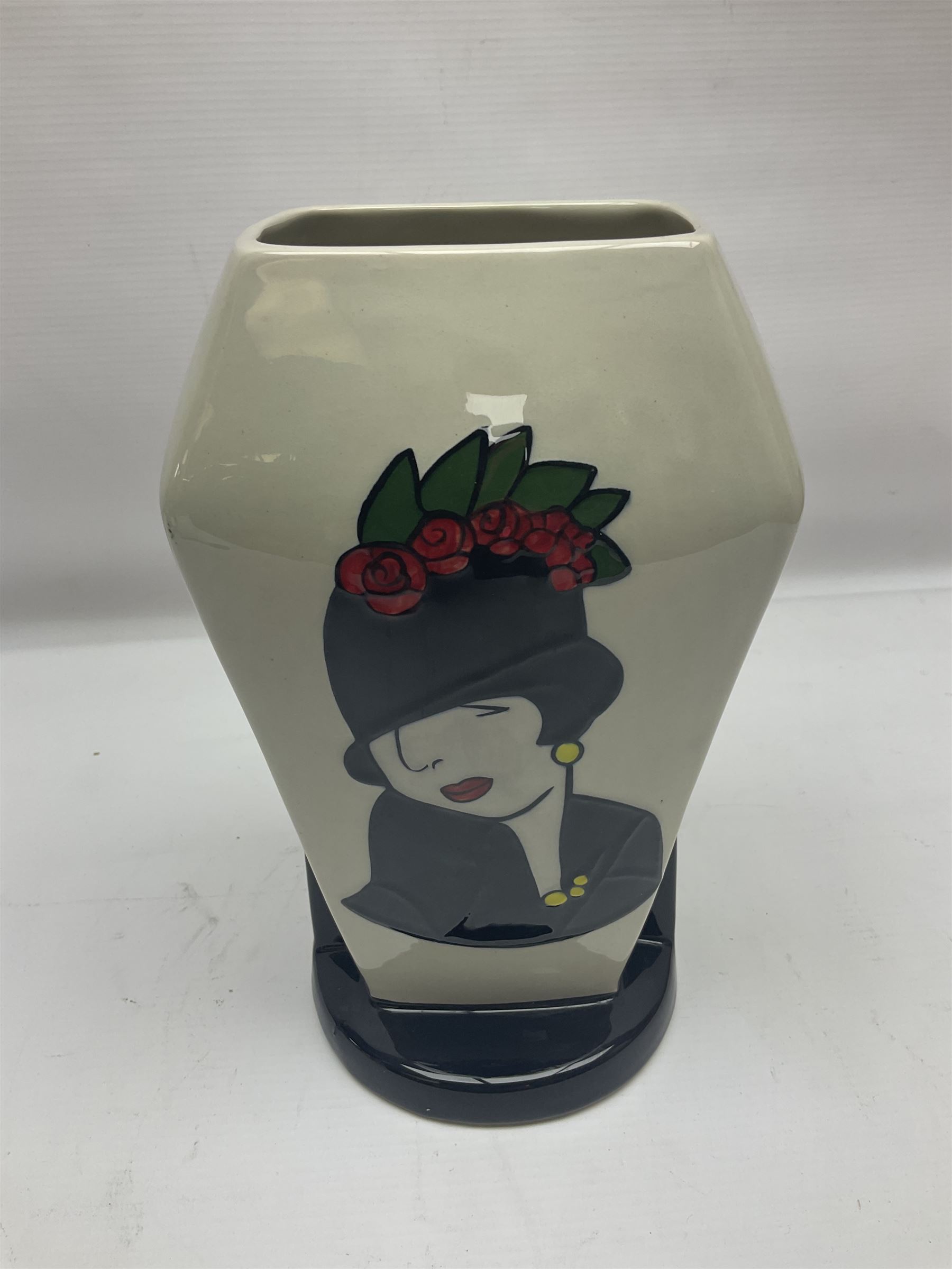 Charlotte Rhead for Crown Ducal ceramics, comprising coffin shaped vase depicting a woman in 1920s dress, a vase with handle, decorated with autumn leaves and a bowl, decorated with flowers and berries, with printed and signed marks beneath, coffin vase H24cm