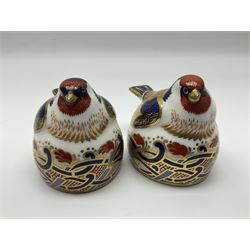 Two Royal Crown Derby Goldfinch Nesting paperweights with silver stoppers, together with two Royal Crown Derby imari pin dishes, largest dish D13cm
