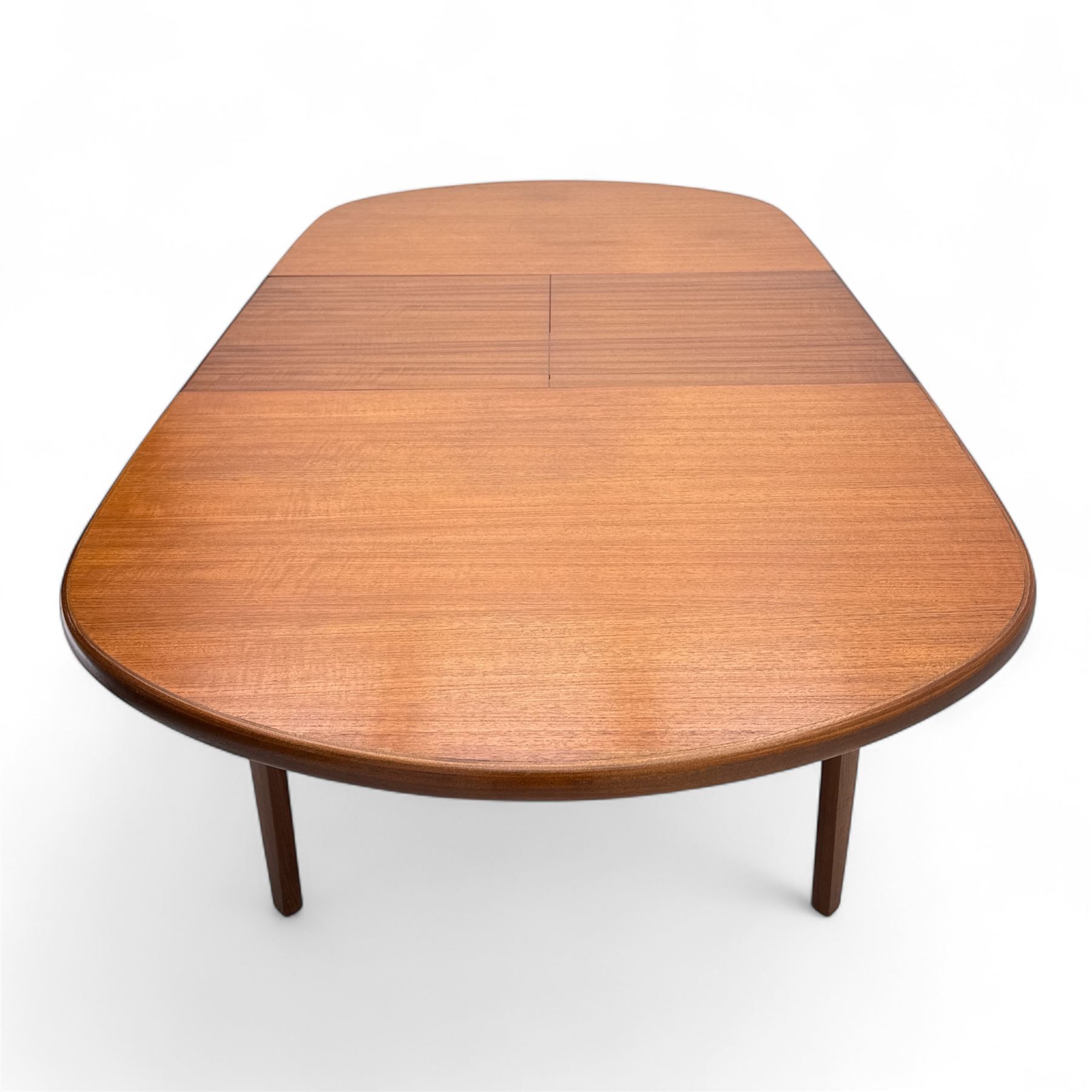G-Plan - mid-20th century teak oval dining table, with butterfly leaf extension mechanism and four Elliot's of Newbury teak framed dining chairs upholstered in purple and green fabric, table un-extended width 152cm x depth 152cm x height 71cm, chairs 47x37x78cm 
