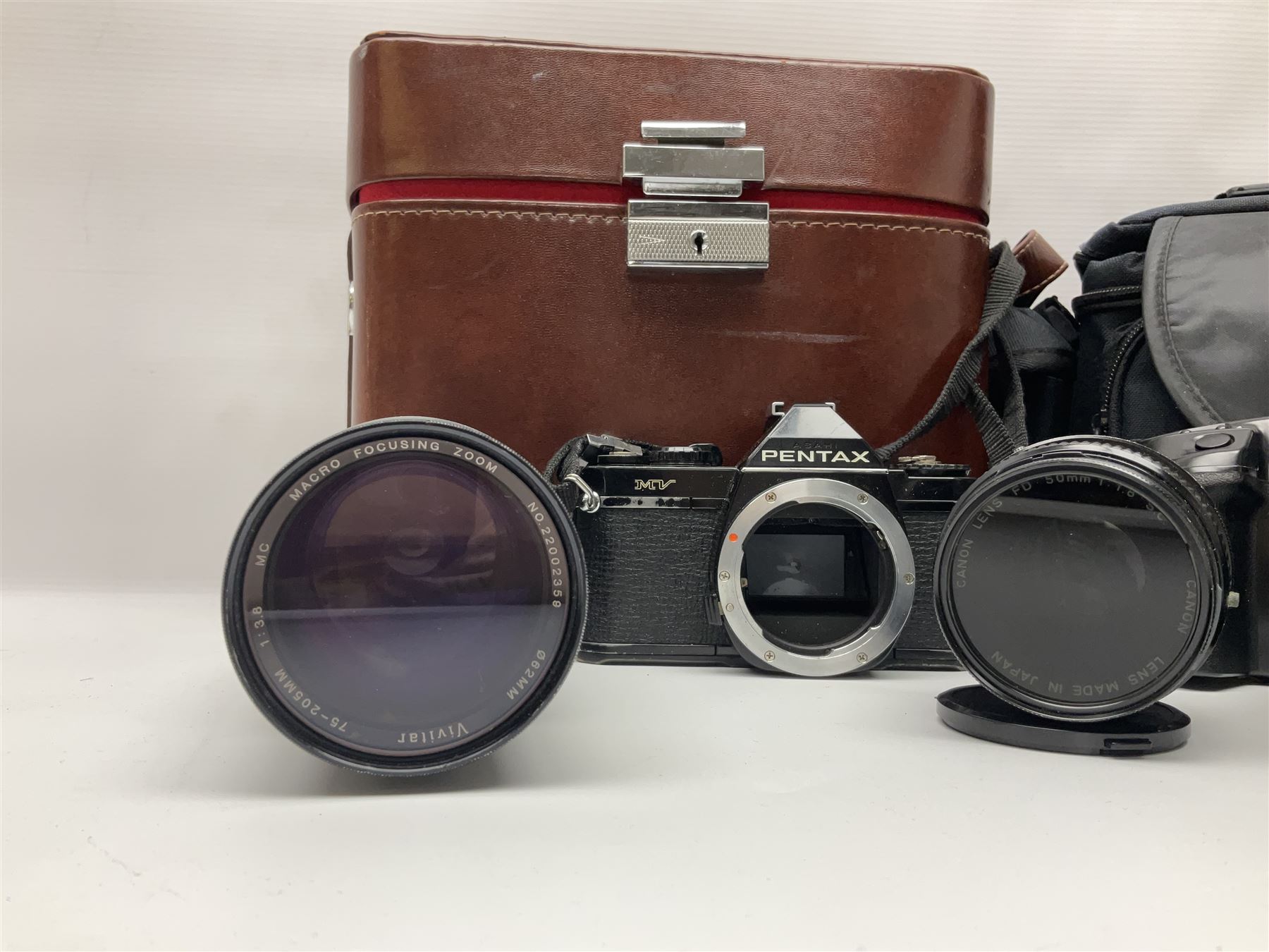 Four Minolta camera bodies, to include Dynax 500si, serial no. 94812651 with 'Signa Zoom 1;3.5-4.5 f=28-70mm' lens, Maxxum 300si, serial no. 97821665, with 'Tamron AF 80-210mm' lens and Dynax 300si, serial no 01603265'  with Minolta AF Power Zoom 35-80mm 1;4' lens, etc, together with Pantax MV1 camera bodies and other camera equipment 