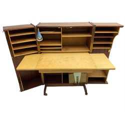 Mummenthaler & Meier - mid-20th century circa. 1960s teak 'Magic Box' folding desk cabinet, the cabinet opens to reveal shelves, writing desk, document holders and lamp, on castors