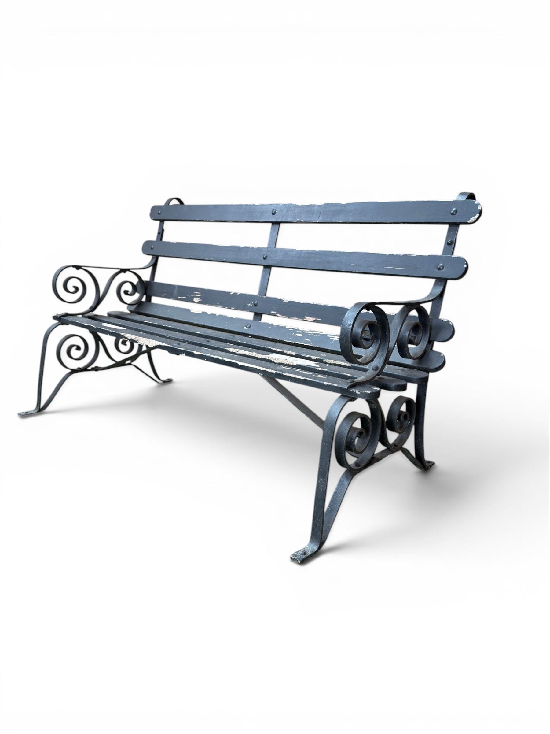 Coalbrookdale - rare pair of wrought iron and slatted wood garden benches, the twin wrought iron strapwork bench-ends formed of four scrolls over splayed feet, number 77 in the Coalbrookdale Castings Catalogue (see illustration)