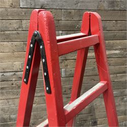 Pair of vintage red painted A frame trestles, with original A W Oates Painter signage