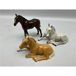 Three Beswick figures of horses, comprising Palomino foal 915, Dapple Grey foal and bay, together with Bing & Grondahl 1852 fledging sparrow modelled as a hungry baby bird and two other animal figures