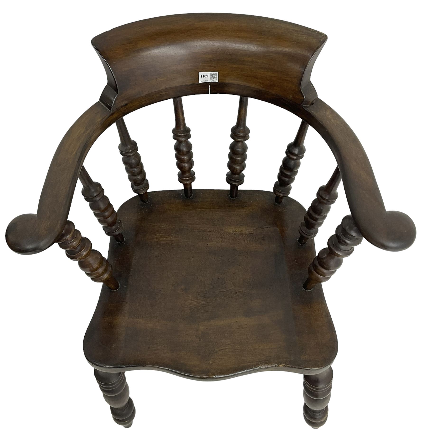 Early 20th century stained beech captains smokers bow chair, spindle tub shaped back over saddle seat, raised on turned supports united by double H-stretcher
