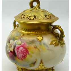  Royal Worcester two handled pot pourri vase and cover, the pierced quatrefoil shaped cover having rosebud finial, the bulbous body painted with roses and lilies amongst foliage by Reginald Austin, on four naturalistic gilded feet, c1913, H21cm   