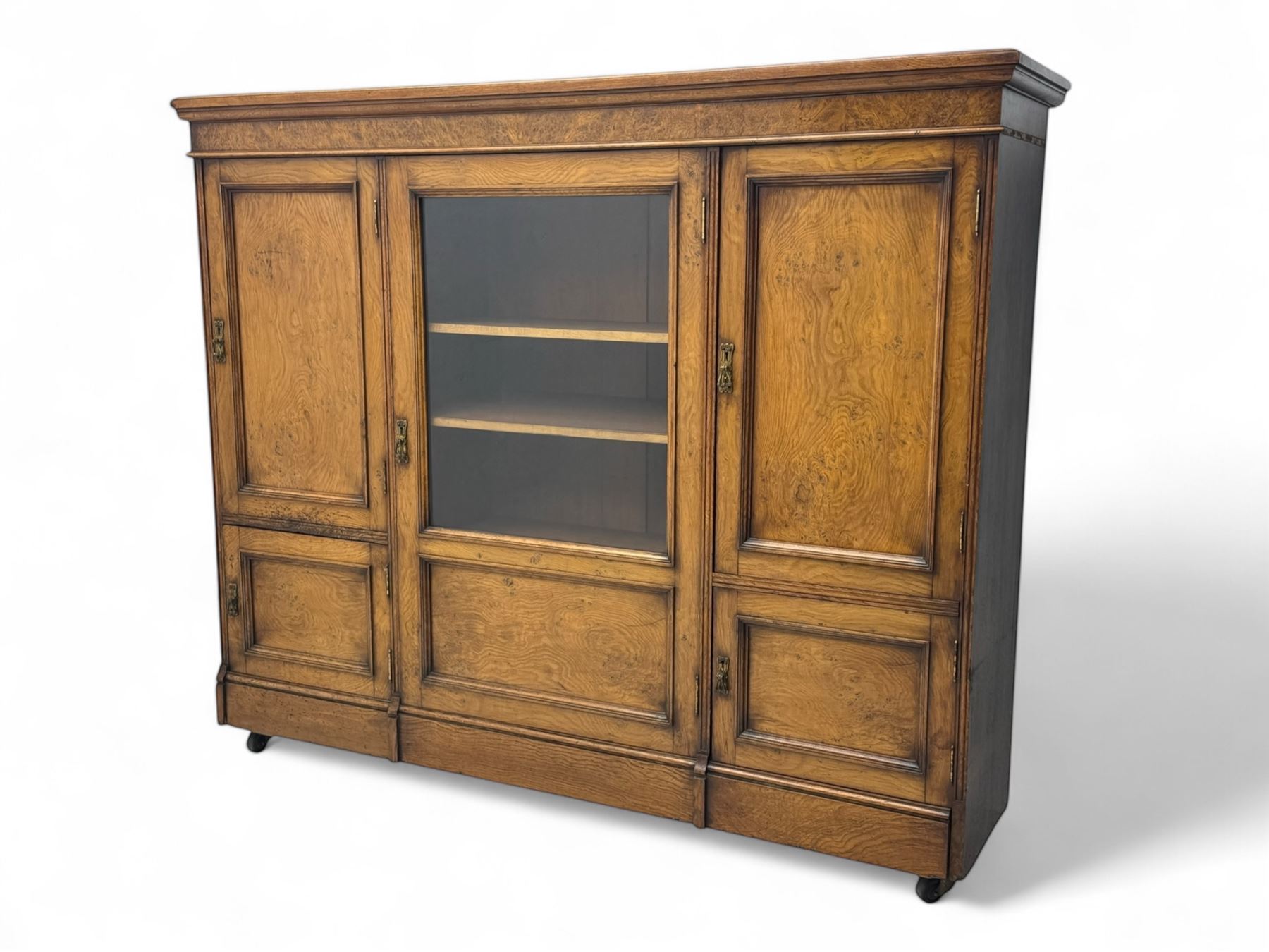 Late Victorian pollard oak bookcase or sideboard, the central glazed door opening to reveal adjustable shelves and interior makers label 