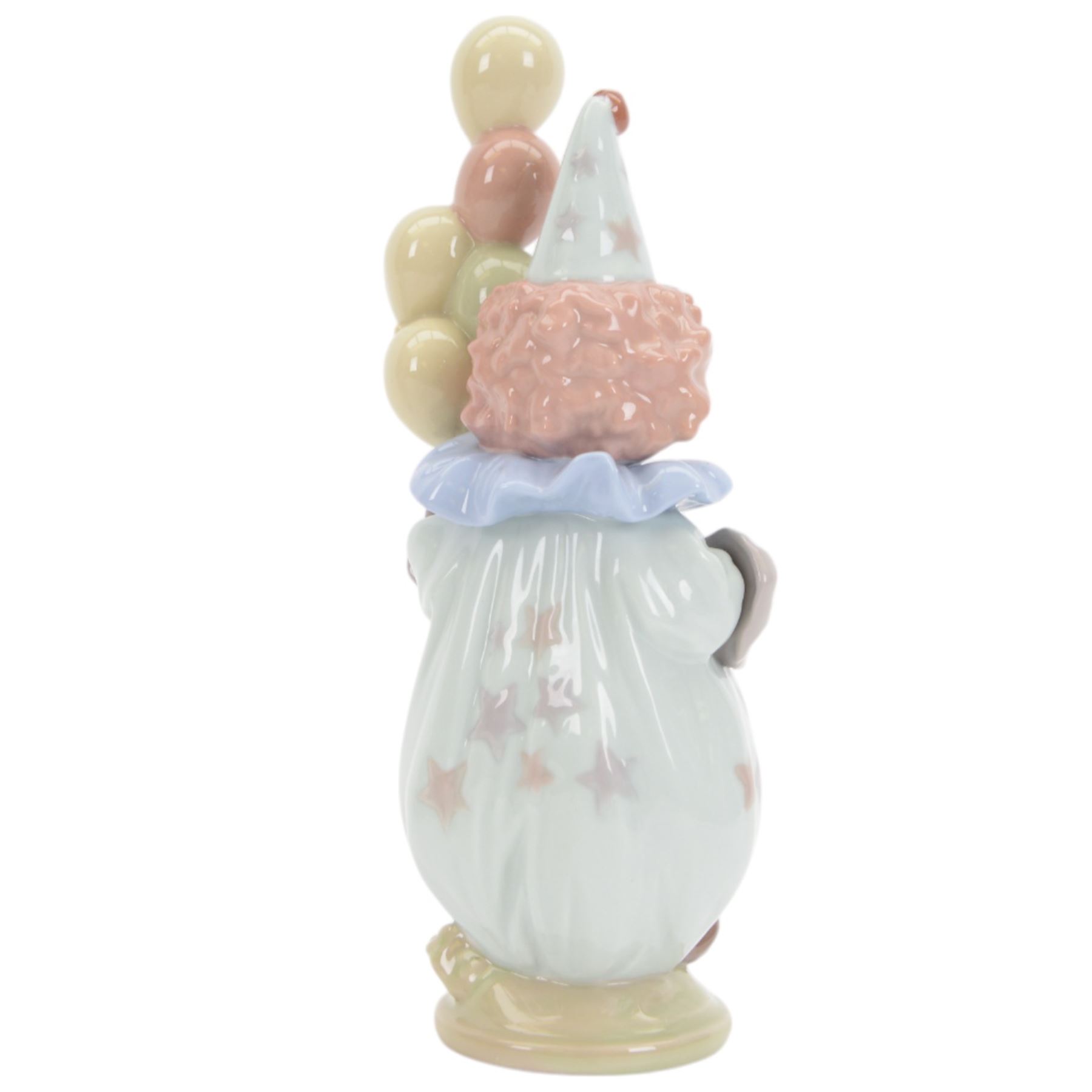 Four Lladro clown figures, comprising Having a Ball 5813, Little Clown 5811, Clown with Puppy 5278 and Pierrot with Concertina 5279