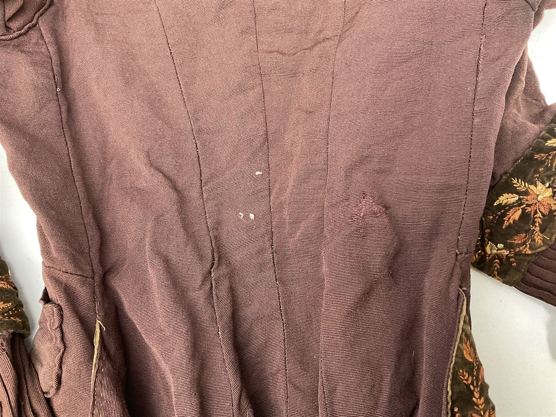 Victorian ladies riding habit, the two-piece construction in brown with embroidered floral velvet edging