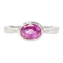 Platinum pink sapphire ring, single bezel set sapphire of approx 1.40 carat, to a planishe...