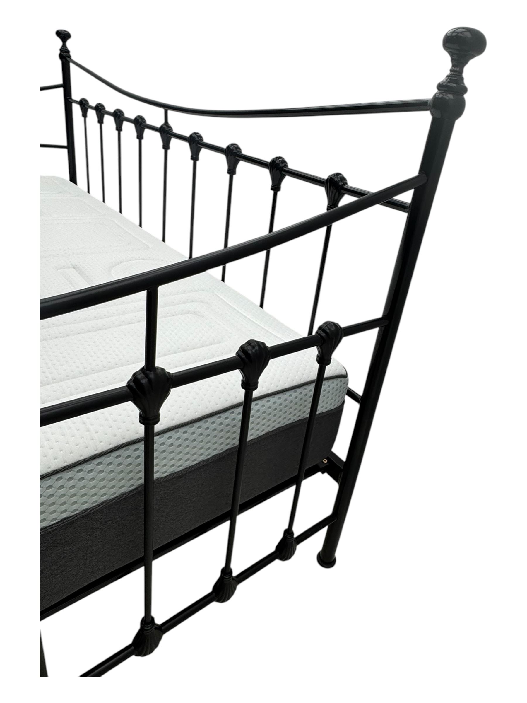 Contemporary Victorian revival black metal day bed, featuring arched back and sides with turned finials and spindle rails, complete with single 'OTTO' mattress