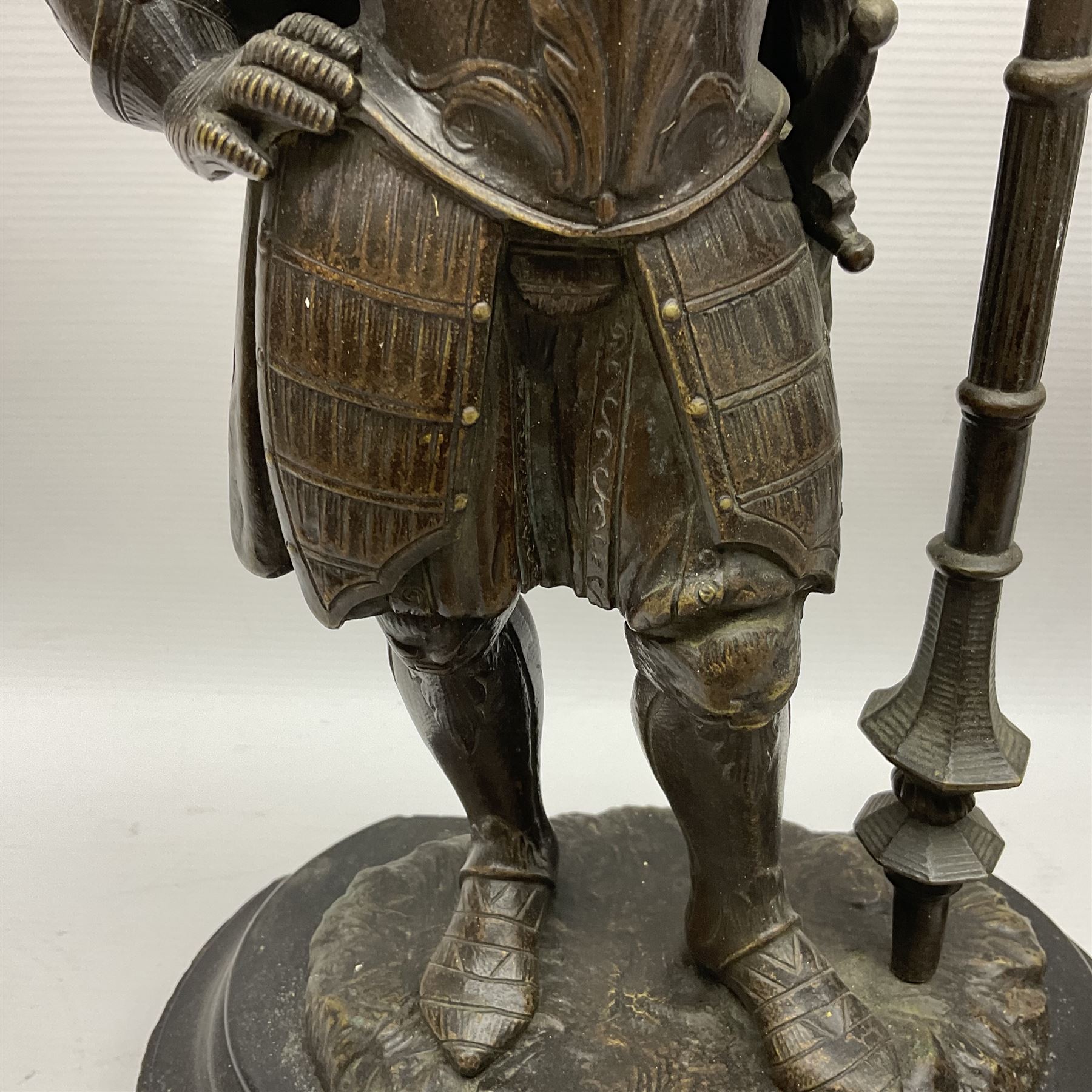 Pair of bronzed figure modelled as a hunter in traditional dress, each holding a pike, H48cm