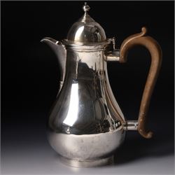 Four piece silver tea and coffee service of baluster form, the tea and coffee pots with domed covers and stained handles London 1916-1918, Maker  C S Harris & Sons Ltd