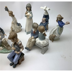 A group of thirteen Nao figurines, together with one Lladro figurine, each with printed mark beneath. 