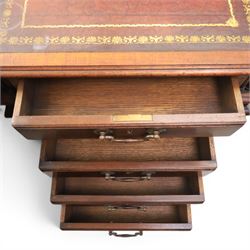George III style large mahogany reverse breakfront partners desk, red tooled leather writing surfaces crossbanded and moulded edges, flanked by ring-turned cluster columns three frieze drawers with brass swan neck handles, raised on large pedestals with faux drawer fronted cupboard and three graduated drawers, supported on carved ogee feet decorated with C-scrolled and acanthus leaves