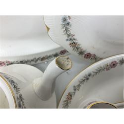 Royal Albert Paragon tea and dinner service for twelve decorated in the Belinda pattern, comprising fourteen saucers, twelve teacups, thirteen side plates, teapot, sauce boat and stand, salt and pepper shakers, two jugs, sucrier, twelve dinner plates, twelve smaller plates, two lidded tureens, twelve bowls, twelve smaller bowls, cake plate, oval plate and oval dish (100)