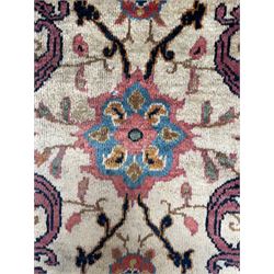Northwestern Persian Meshkin hand-knotted carpet, the ivory field with an all-over design of scrolling vines and stylised floral sprays in burgundy, pink, and blue tones, enclosed by a raspberry red border of rosettes and palmettes linked by fine arabesques, from the region of Meshkin near Ardabil