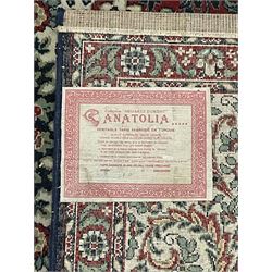 Persian design crimson ground carpet, the central rosette medallion surrounded by scrolling leaves and flower heads, the spandrels decorated with floral design and scrolling foliage, repeating border within guard stripes