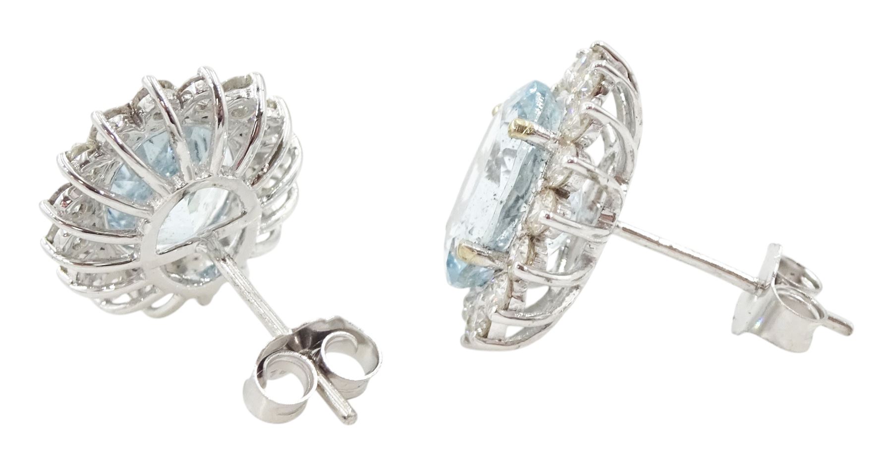 Pair of 18ct white gold oval cut aquamarine and round brilliant cut diamond cluster stud earrings, total aquamarine weight approx 4.65 carat, total diamond weight approx 1.00 carat