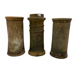 Three Victorian terracotta chimney pots with decorative banding 