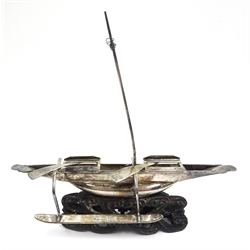  Early 20th century Chinese silver model of a dragon boat, with rowers and musicians, marked, 15.5cm long, similar gun boat 11cm and a rowing boat 13cm all on carved hardwood stands, two bearing character signatures  