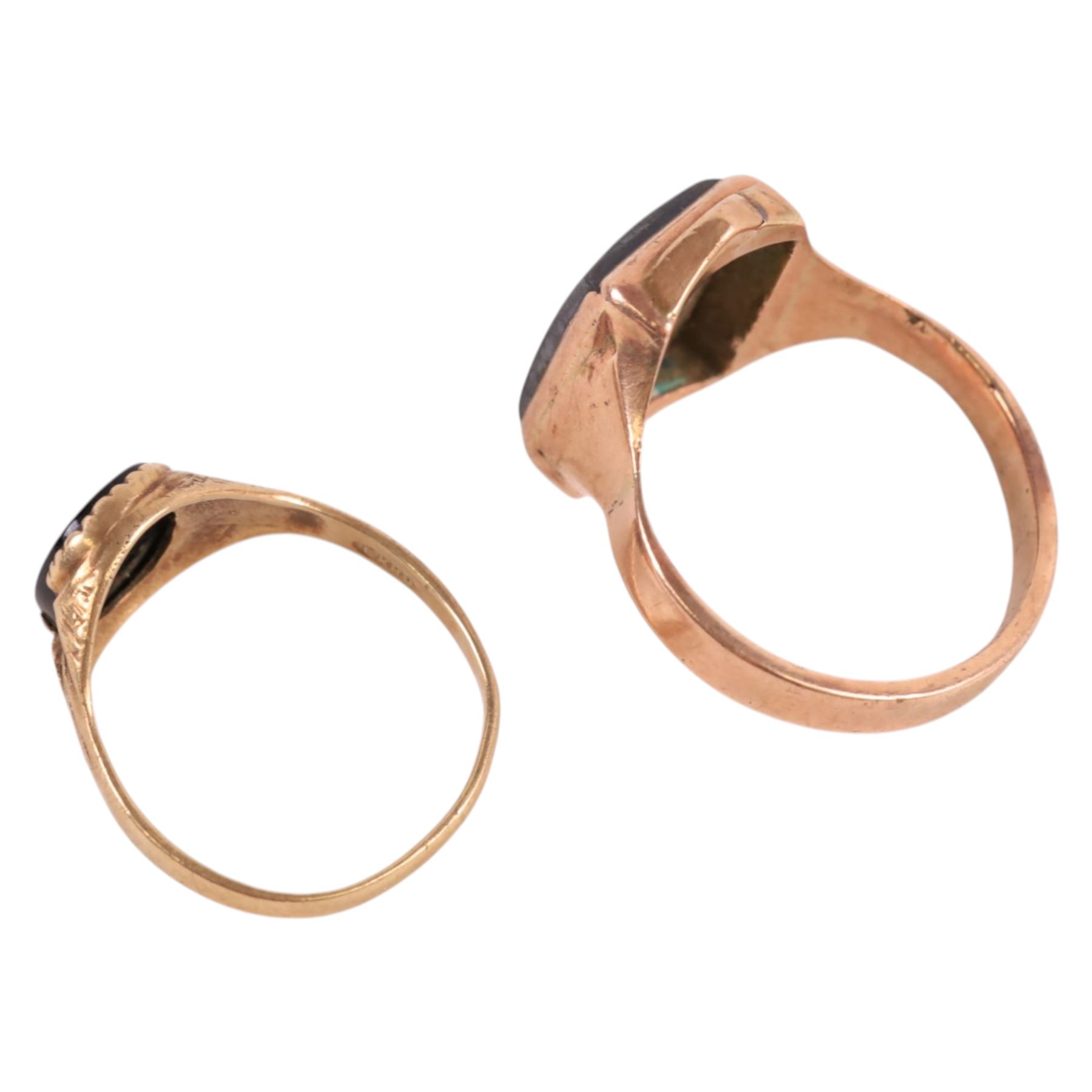 Two 9ct gold signet rings, comprising haematite example with carved warrior head and black onyx example
