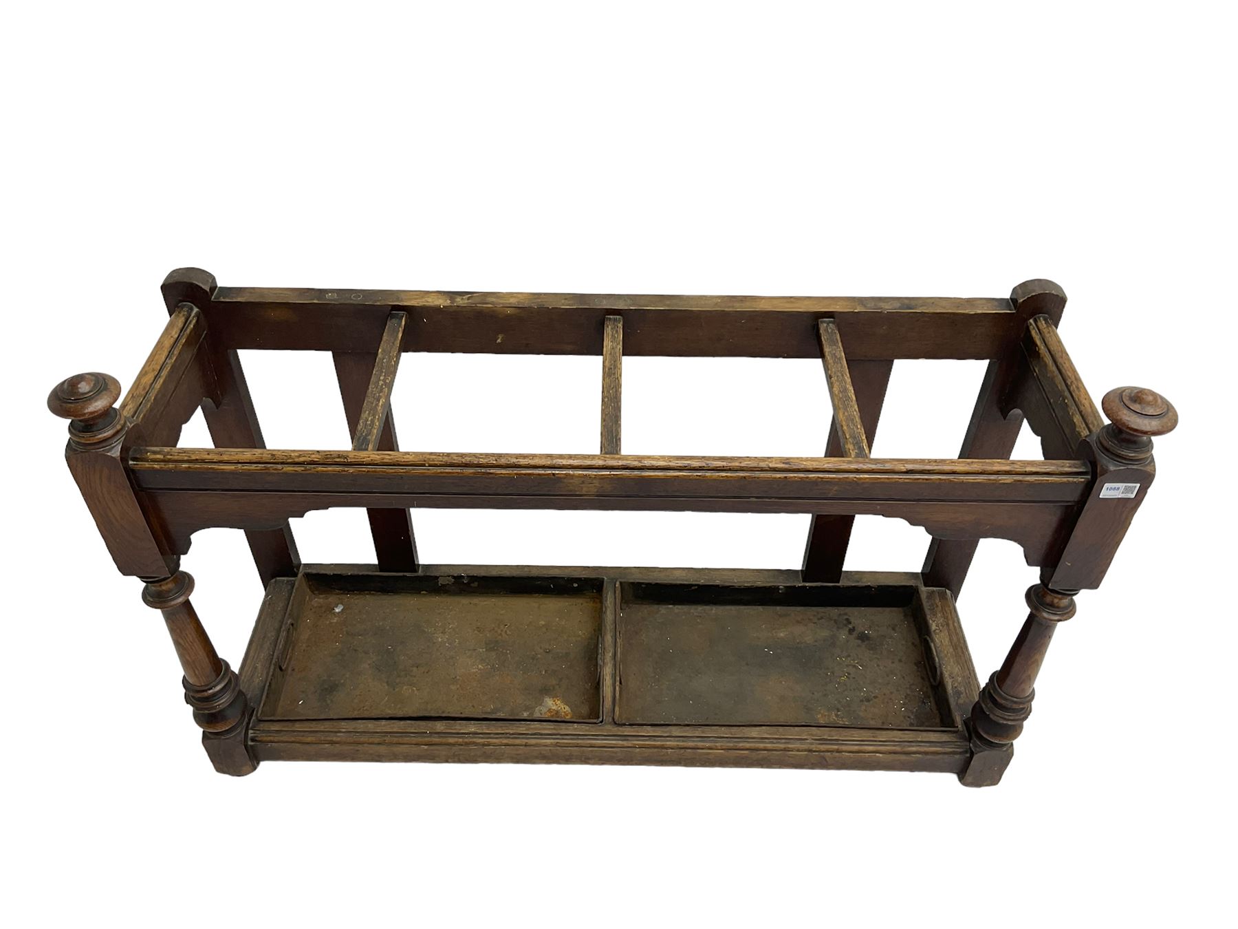 Edwardian oak hallway stick and umbrella stand, four divisions on turned supports, with metal tray liners and various sticks