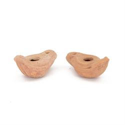 Antiquities; two late Roman Christian terracotta oil lamps 4th century AD, decorated with ...