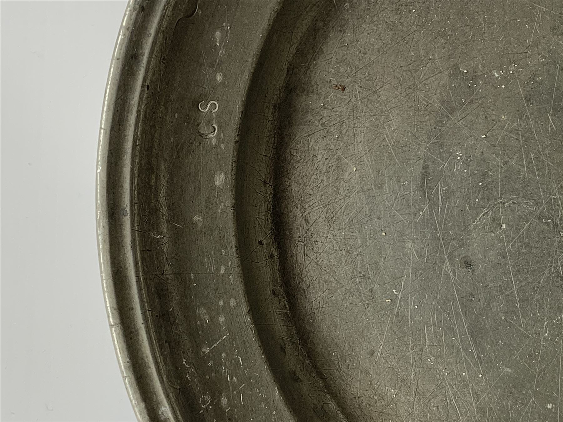 Collection of 18th and 19th century pewter, comprising two chargers, eight large plates, twenty six smaller plates, two bowls, three lidded measures, two jugs, tappit hen, and tankard, the plates with various marks and touch marks, including pseudo 'hallmarks', largest charger 37cm, large plates D30cm, smaller plates D24.5cm, tappit hen H26.5cm