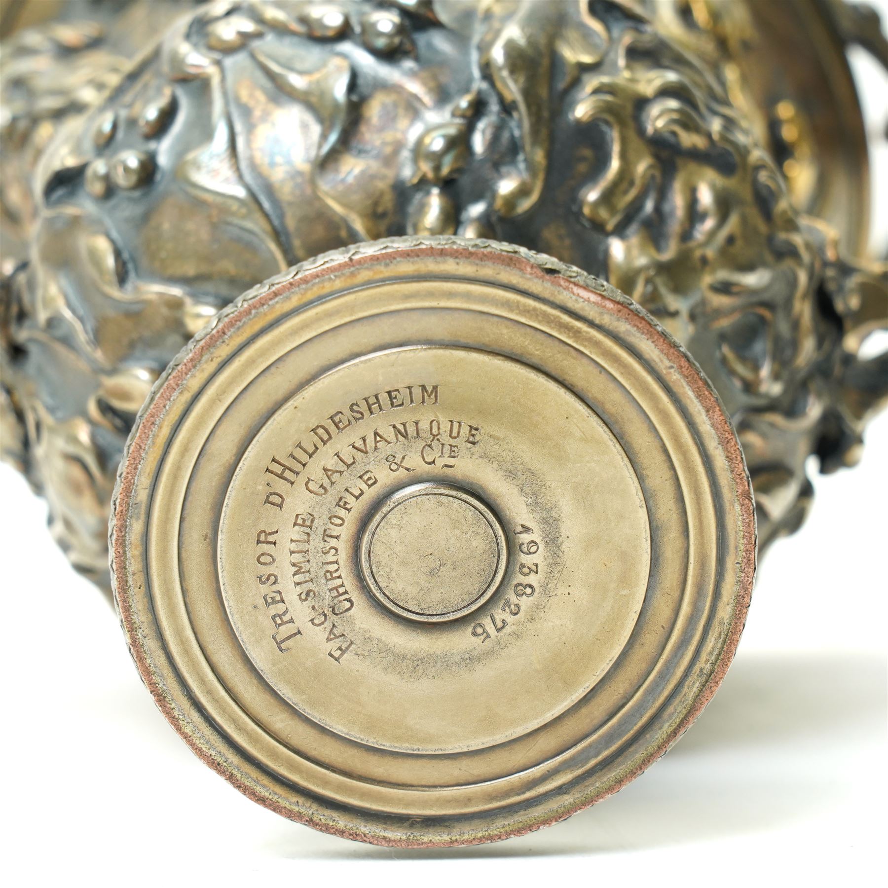 Christofle 'Tresor d'Hildesheim' facsimile gilt metal two handled cup decorated with masks, leaves etc H13cm and a bowl from the same collection with two handles and a raised pattern of leaves on a pedestal foot D19cm (2) 