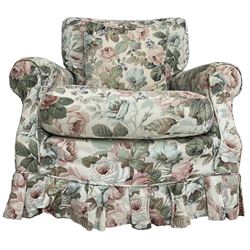 Traditional shaped armchair, with loose cushions and scatter cushion upholstered in loose floral cover, on castors, calico upholstered cover underneath 