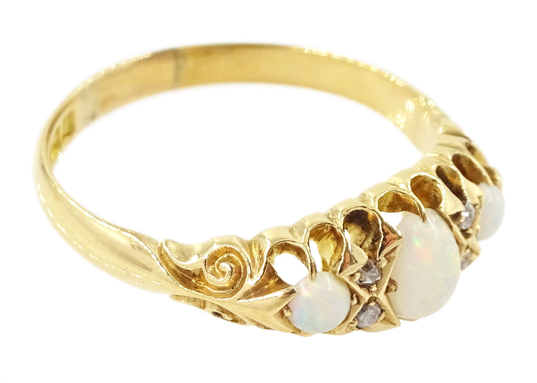 Edwardian 18ct gold opal and diamond ring, three cabochon cut opals, the principal stone with two round cut diamonds set either side, Birmingham 1910