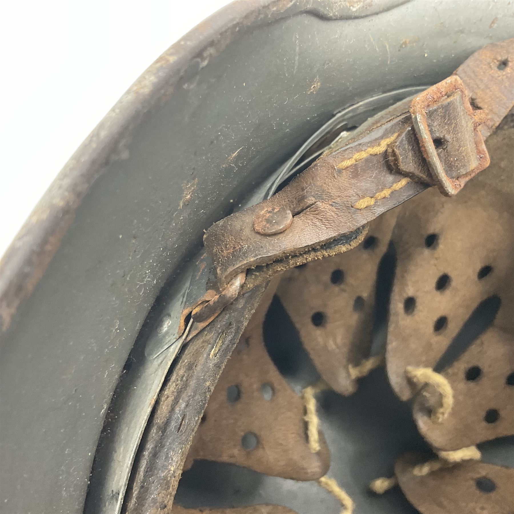 WW2 German Infantry M40 steel helmet with tropical finish and traces of single decal; with chin strap and leather liner marked 57 twice in red; back apron stamped 11 38