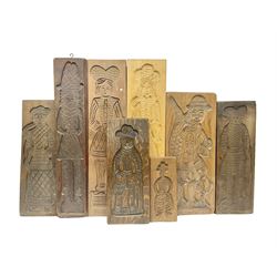 Eight 20th century hardwood Dutch folk art Speculaasplank or biscuit moulds, most examples typically carved with figures in traditional dress, tallest H60cm