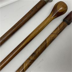 Three early 20th century walking sticks, to include a smoking pipe walking stick, the cane opening to reveal a concealed pipe, and a wooden walking cane, the metal cover with inscription 'bell metal and wood of York Minster, Burnt May 20 1840, and a turned wooden walking stick, with marquetry checkerboard pommel, tallest L90cm