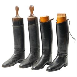 Two pairs of leather riding boots with wooden trees