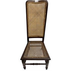 Early 19th century stained beech and mahogany child's correction chair, cane seat and back raised on turned supports united by stretchers